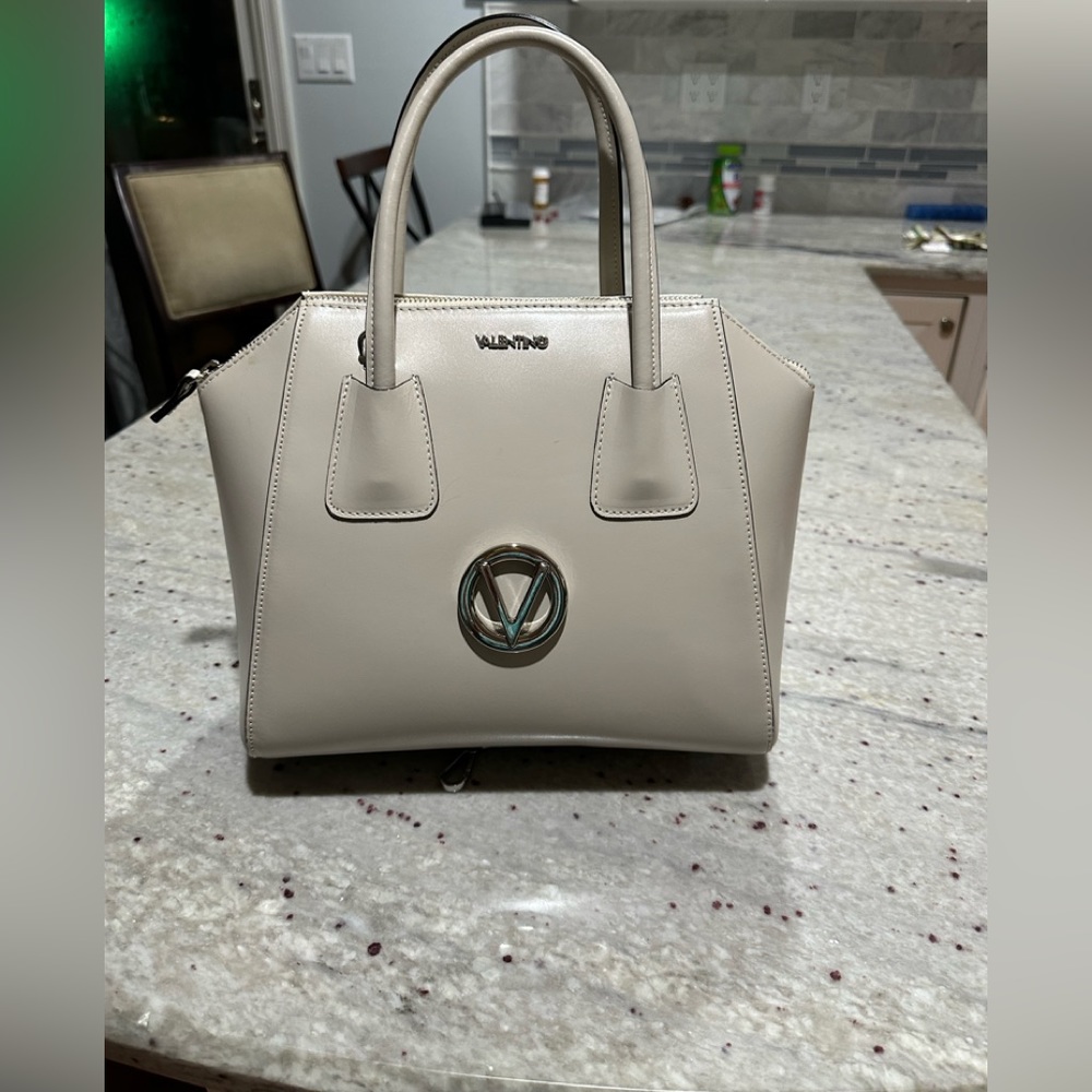 New Valentino handbag. Comes with handles and strap.